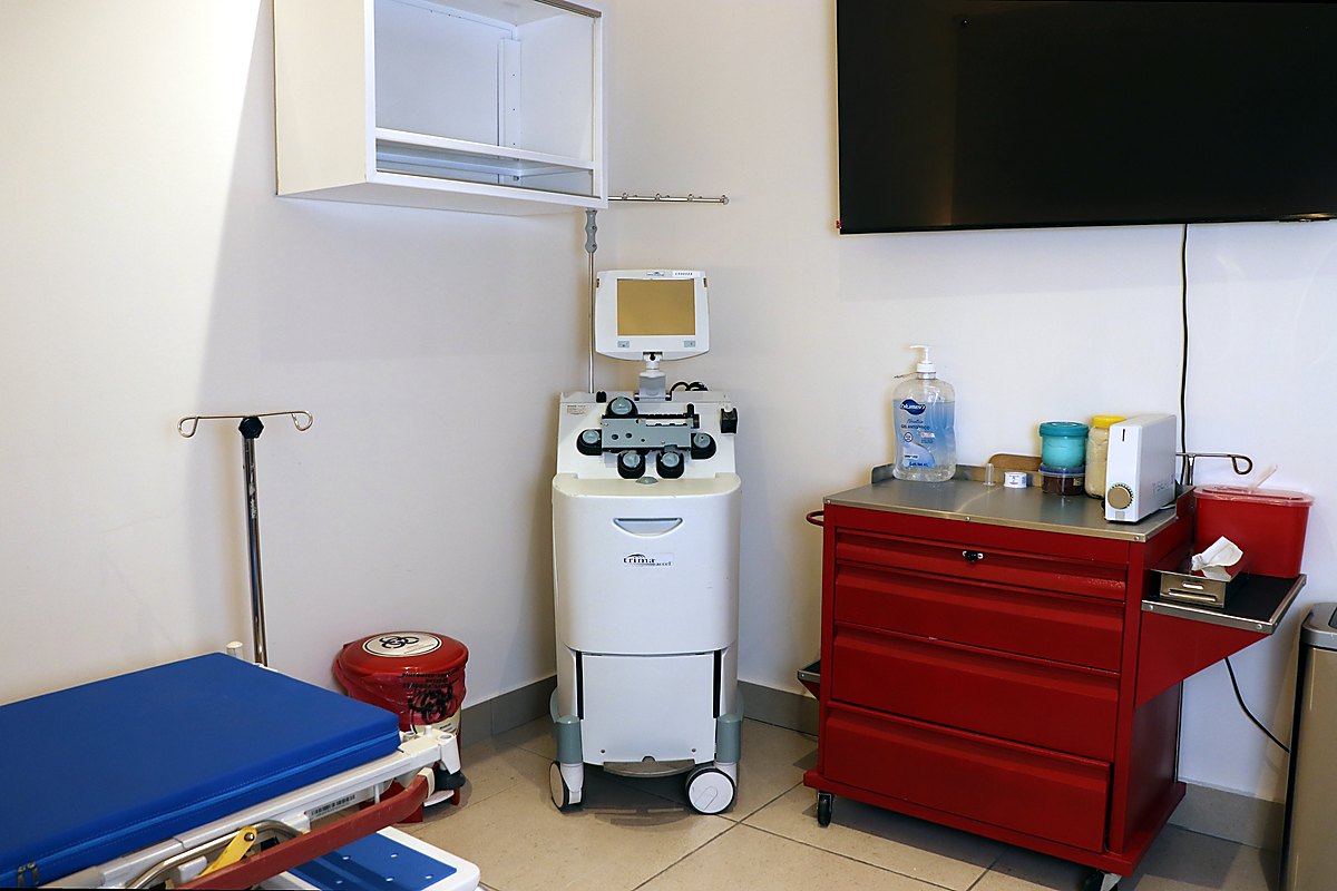 Esquina de la sala de donación con carro rojo, contenedores para residuos biológico-infecciosos y equipo de aféresis.